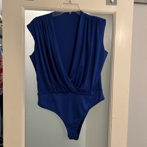 Body suit with shoulder pad